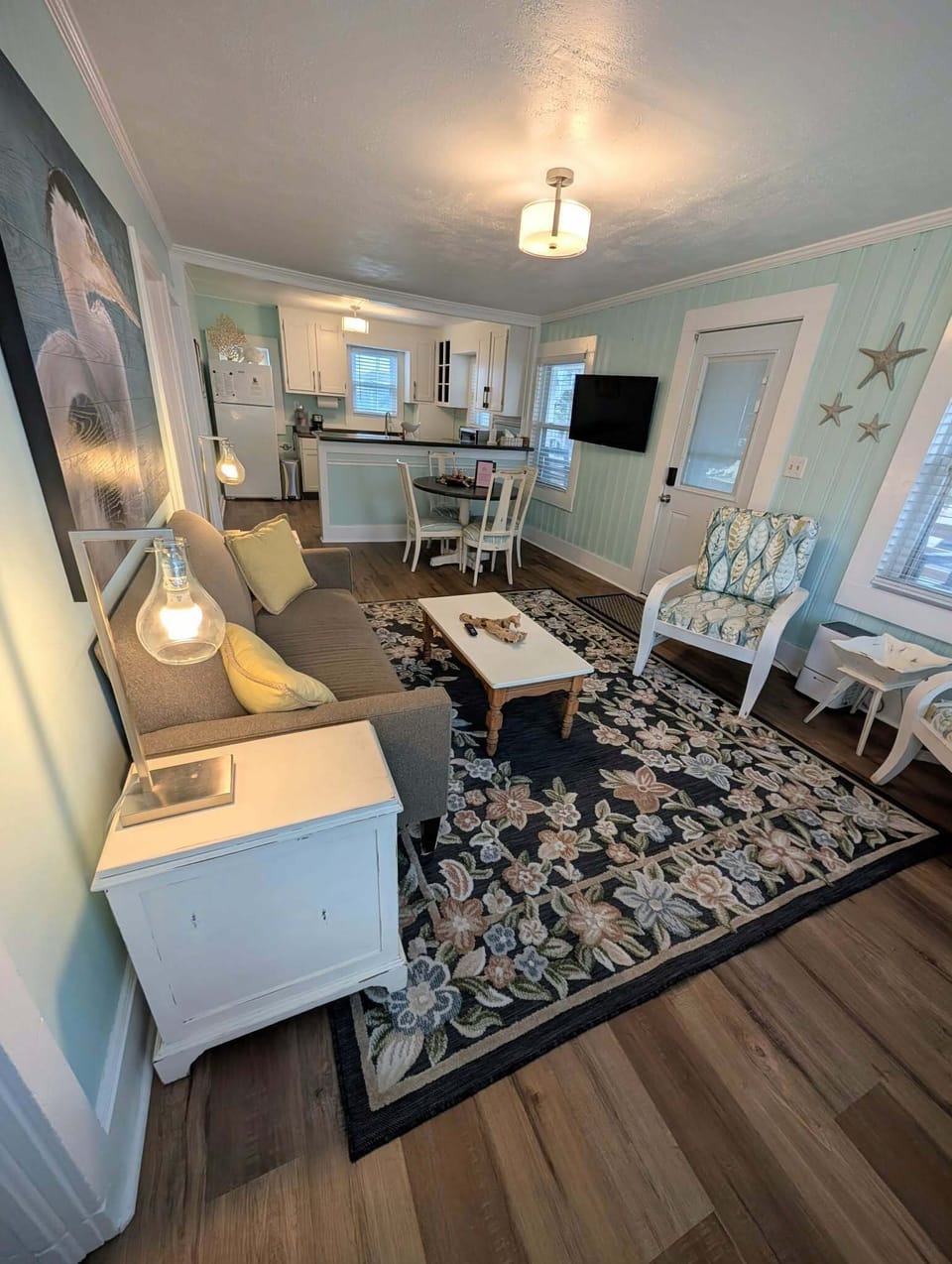 Relaxing coastal living space with smart TV and comfortable seating.