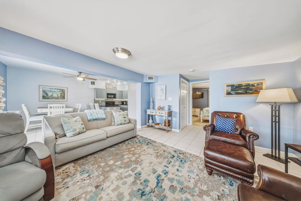 Unwind in the bright and welcoming living area, complete with a large Smart TV and easy access to the kitchen, dining space, and outdoor canalfront amenities.