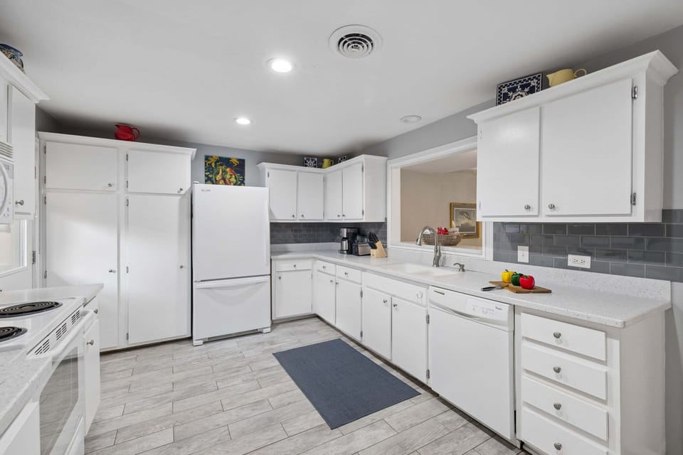 Gather around the heart of the home in this bright and welcoming kitchen, thoughtfully designed for easy vacation living