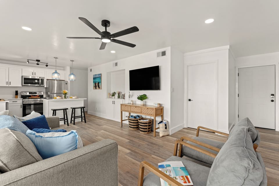 Expansive view of the main living area demonstrating the seamless transition into the dining and kitchen spaces.