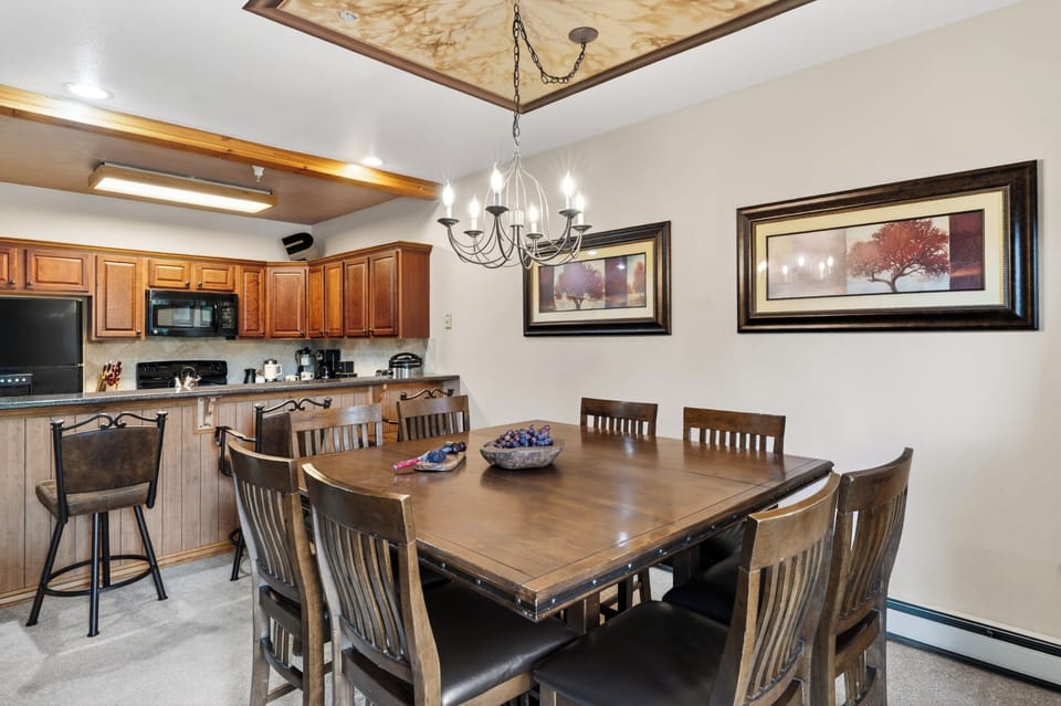 Dining area with seating for eight, warm lodge-style details, and easy kitchen access.