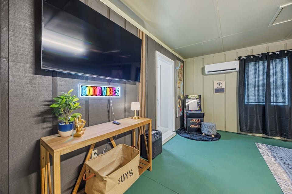 Cozy media room with big-screen TV, A/C, and fun modern decor