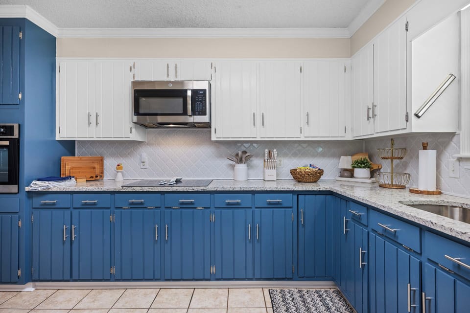 Bright updated kitchen with blue cabinetry and spacious counters