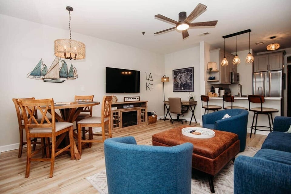 Enjoy family time in this open-concept living and dining area, featuring cozy seating, a Smart TV, and electric fireplace —perfect for meals, games, or simply unwinding after a day by the lake. Couch opens to a queen bed with upgraded mattress.

