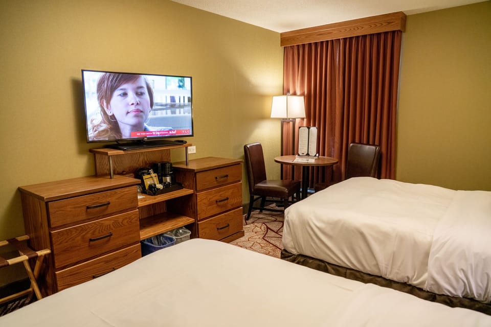 Flatscreen TV and mini fridge set up for downtime — drip coffee maker ready for your morning before heading out.