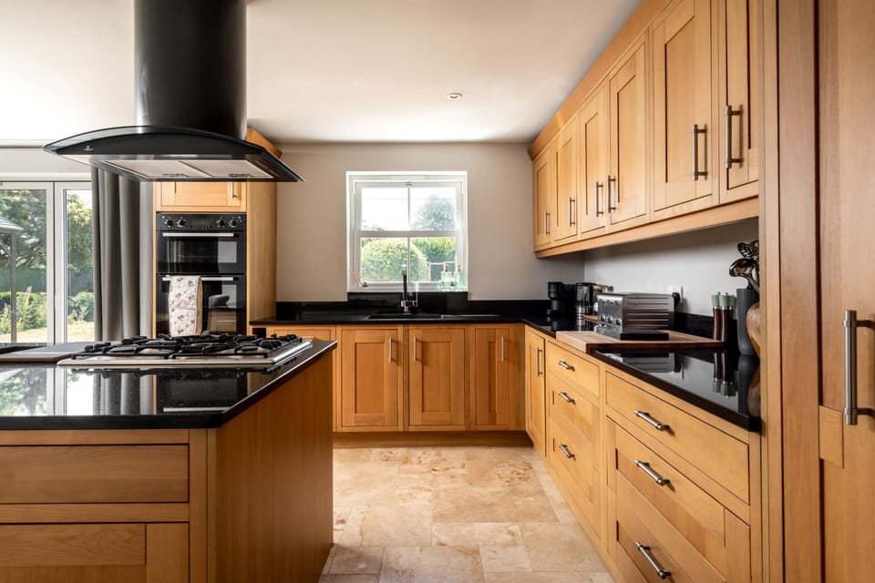 Family kitchen fully stocked with crockery, glassware, dishwasher