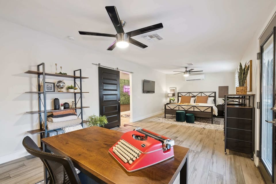 Enjoy a large wooden desk, sleek open shelving, and the comfort of a king-sized bed just steps away. A creative oasis designed for work, rest, and effortless style.