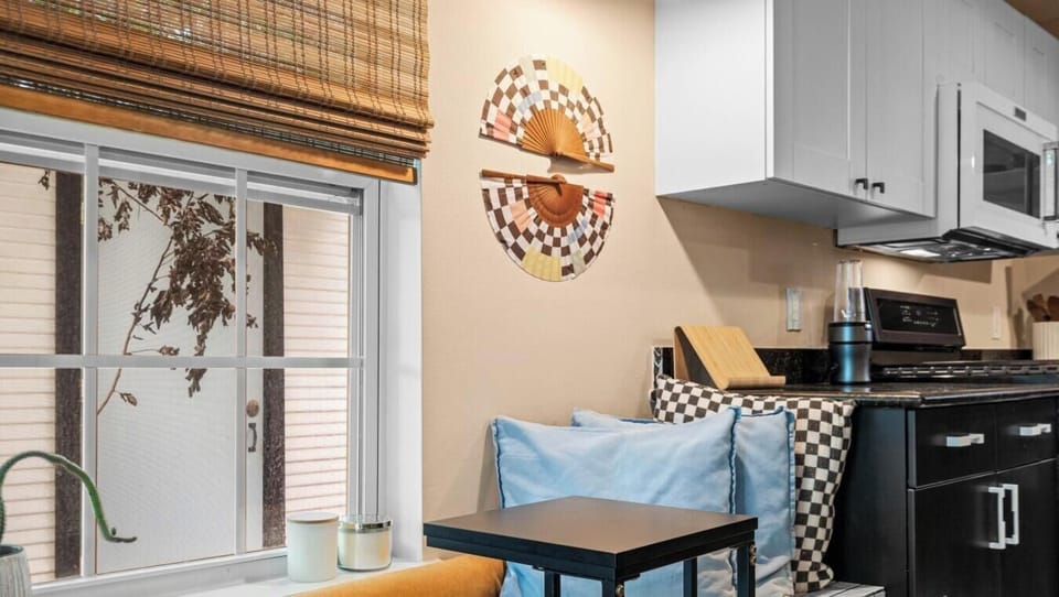 The cozy breakfast nook bench is an ideal spot to sip your morning coffee beside sunny windows.