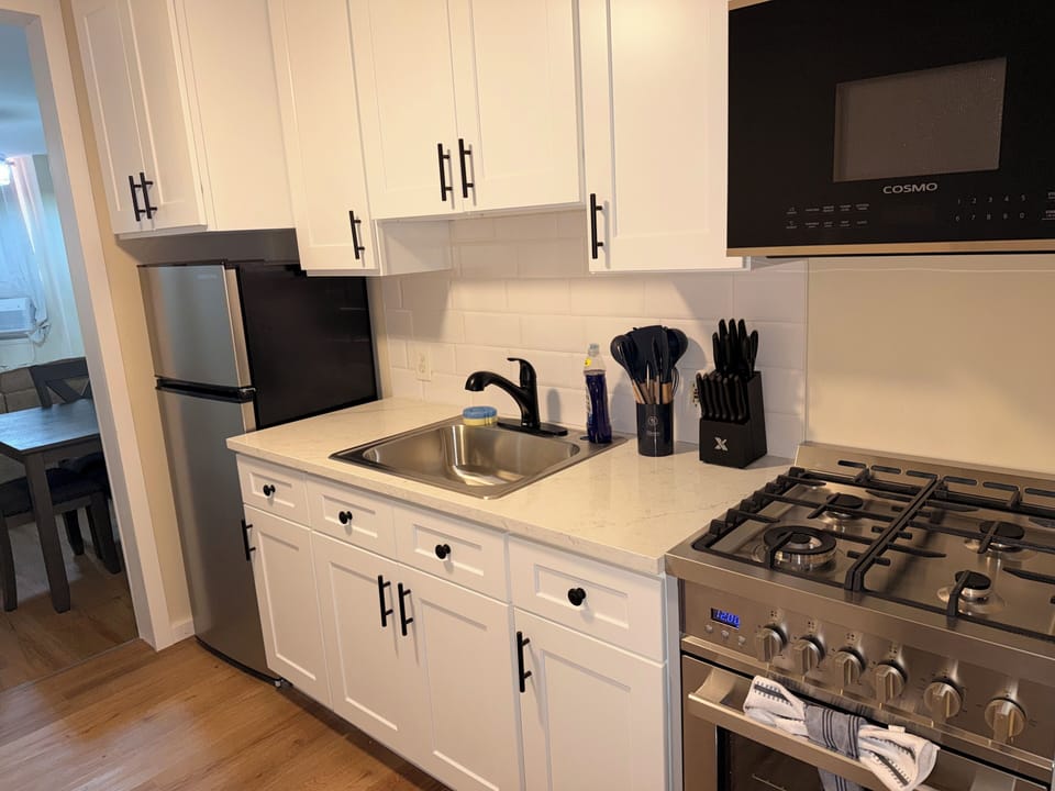 Bright modern kitchen with gas range and stylish white cabinetry