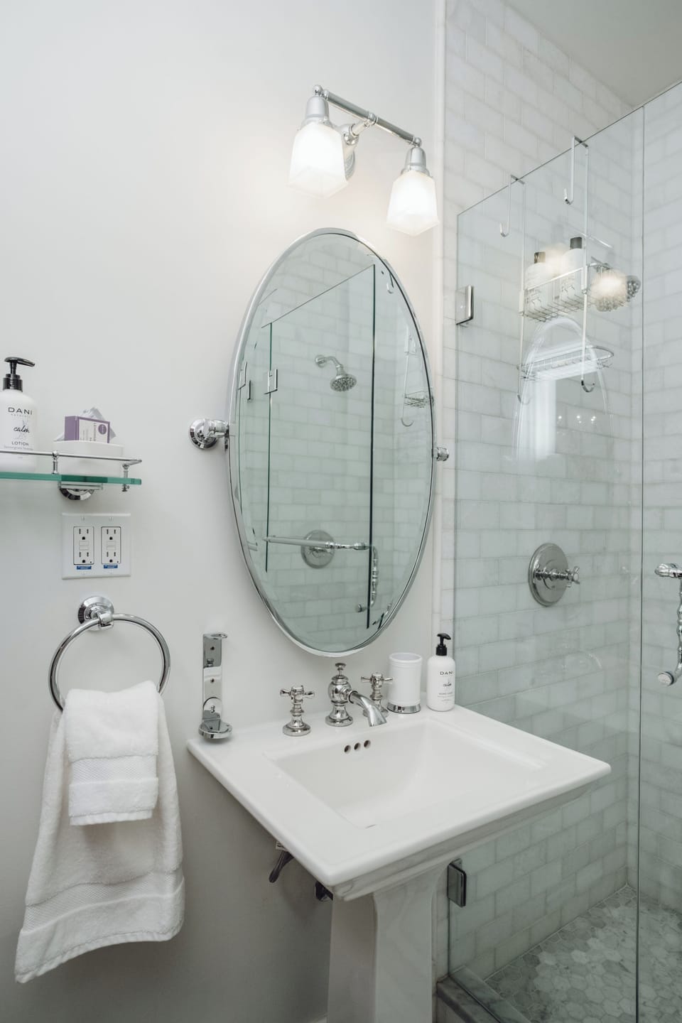 Bright spa-like bathroom with glass shower and elegant finishes