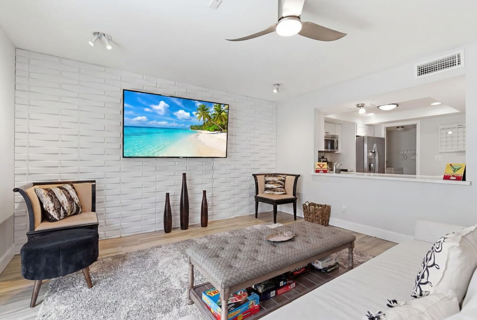 Chic living room with a comfy sofa that doubles as a sleeper, Smart TV, board games, and private patio access for easy indoor-outdoor relaxation.
