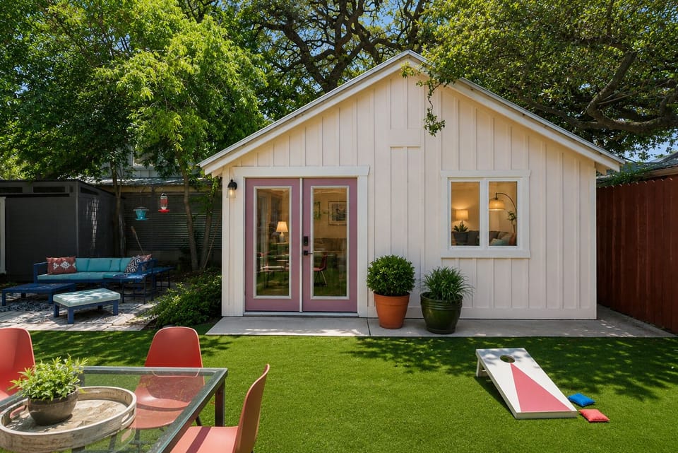 house is accessed from side yard, has sitting area, game in the yard