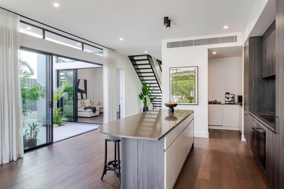 Master ensuite bathroom, double vanity, full-height tiling, freestanding bath + private shower