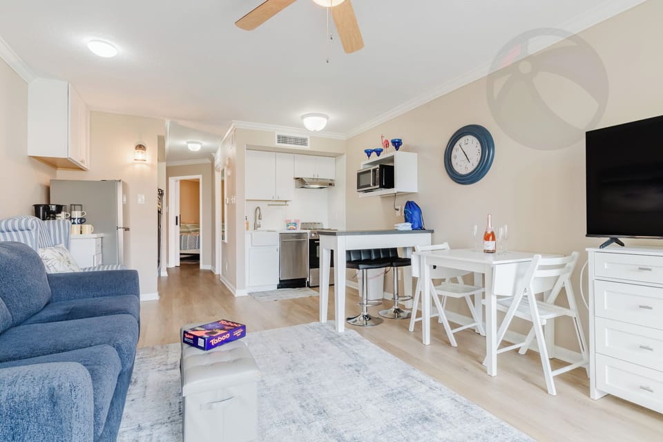 Looking in from the balcony door you see the open concept living/dining/kitchen