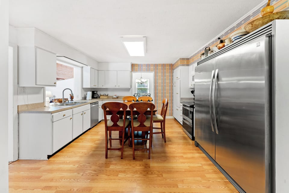 Huge Commercial Stainless Fridge in the eat in kitchen