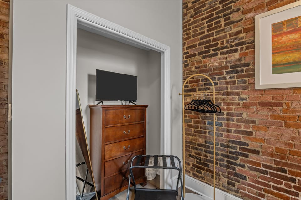 Smart Tv, clothing rack, suitcase rack, and full-length mirror 