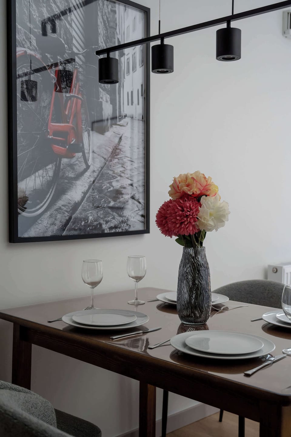 Dining space with a table set for four, seamlessly connected to the living room.