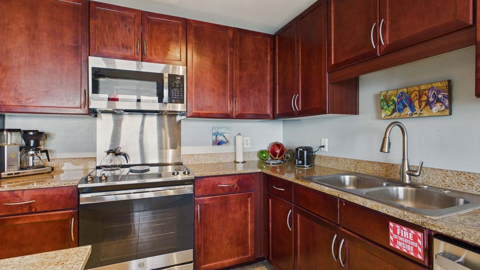 Fully applianced kitchen with island and breakfast seating. Equipped with all the cooking essentials for your stay.