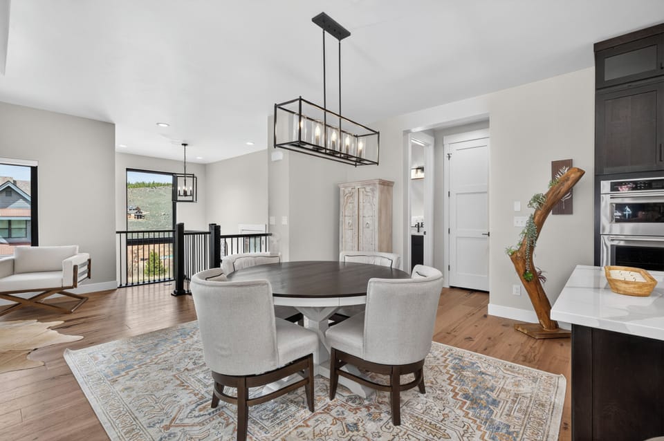 Gather around this elegant dining table where your meals become memorable moments, framed by beautiful natural light and thoughtful design touches throughout the open-concept space.