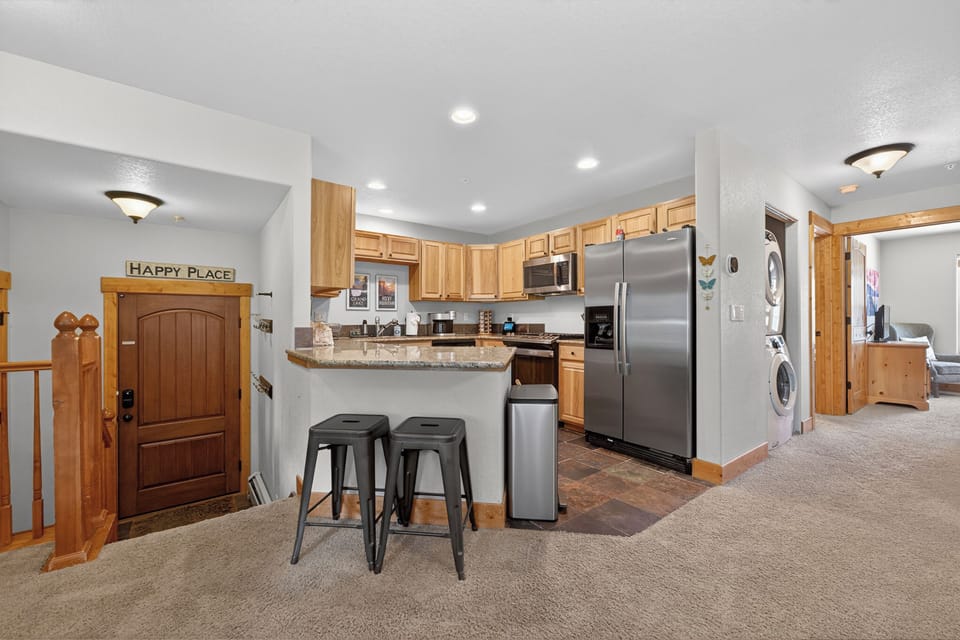 Prepare your favorite meals in this fully equipped kitchen with stainless steel appliances, granite counters, and an inviting breakfast bar—perfect for morning coffee or casual dining.