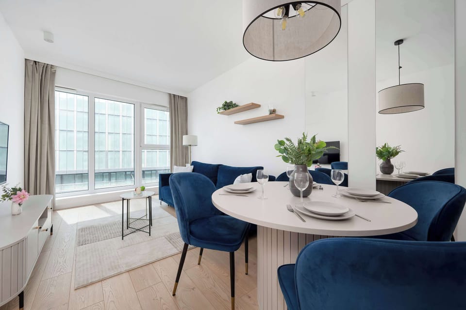The living area features a sleek coffee table and a flat-screen television.