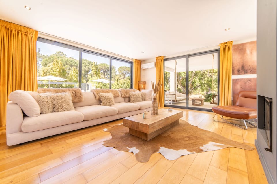 Open-plan lounge with glass façades — Villa Solare, holiday villa with heated pool frontline to Quinta do Perú golf, Azeitão near Lisbon
