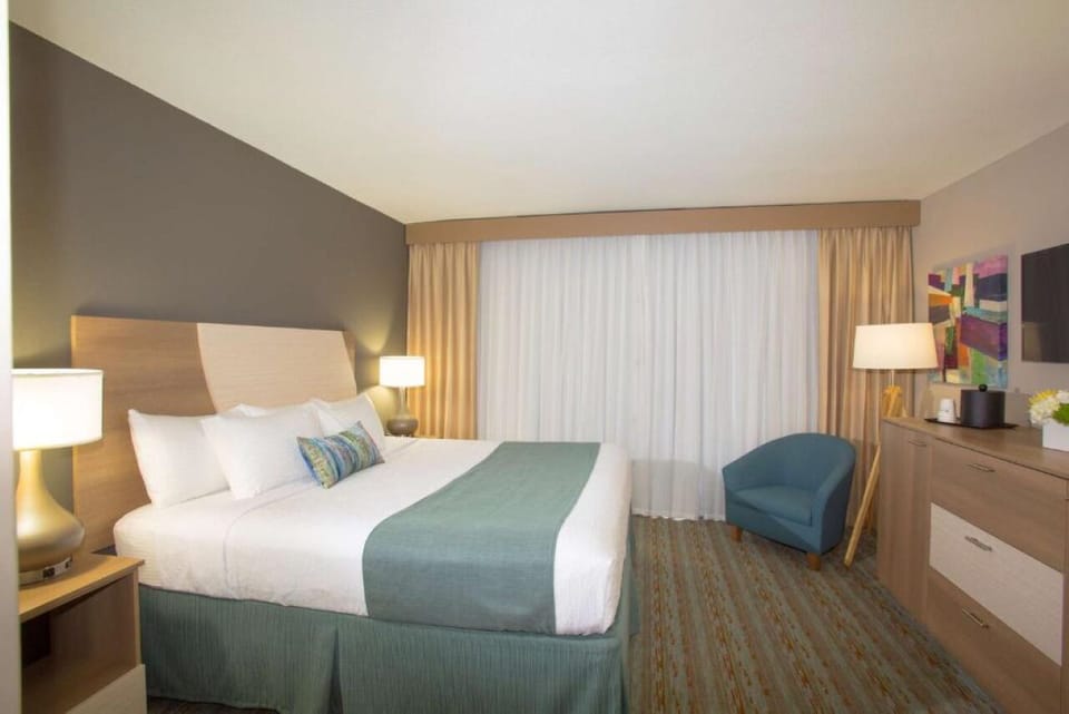 Unwind in a crisp, spacious room with cozy seating.