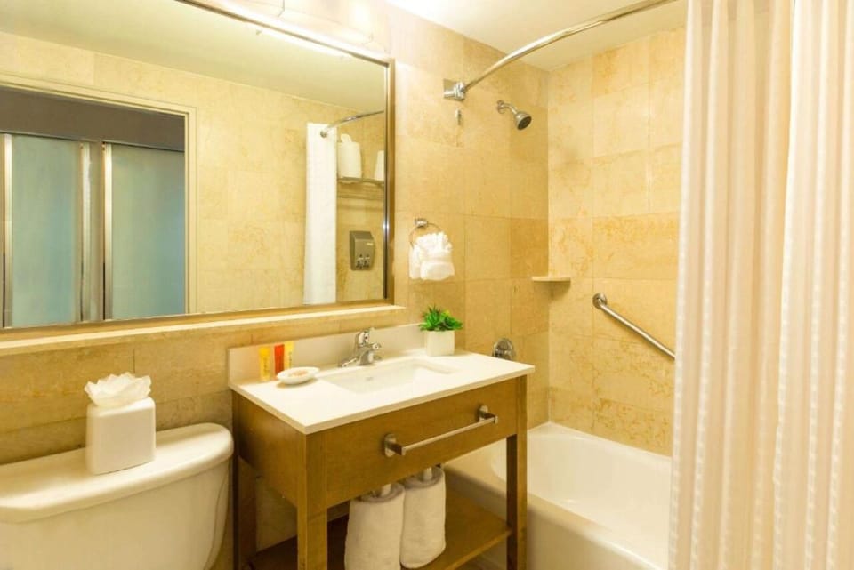 Rinse off in a spotless shower-tub with plush towels ready.