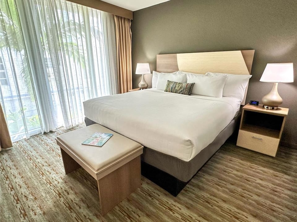 Sink into a cloud-soft bed by sunny window drapes.