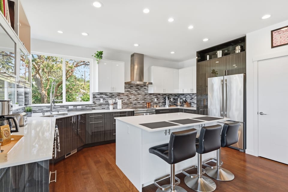 Bright modern kitchen with island seating and sleek stainless appliances
