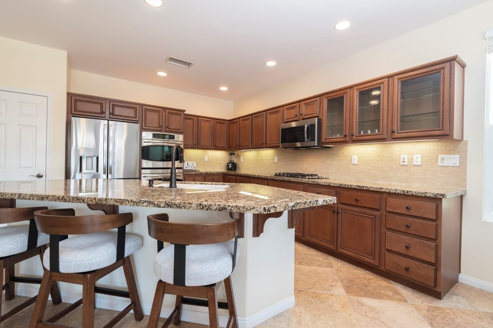 Kitchen Island with swivel bar stools and granite countertops. 