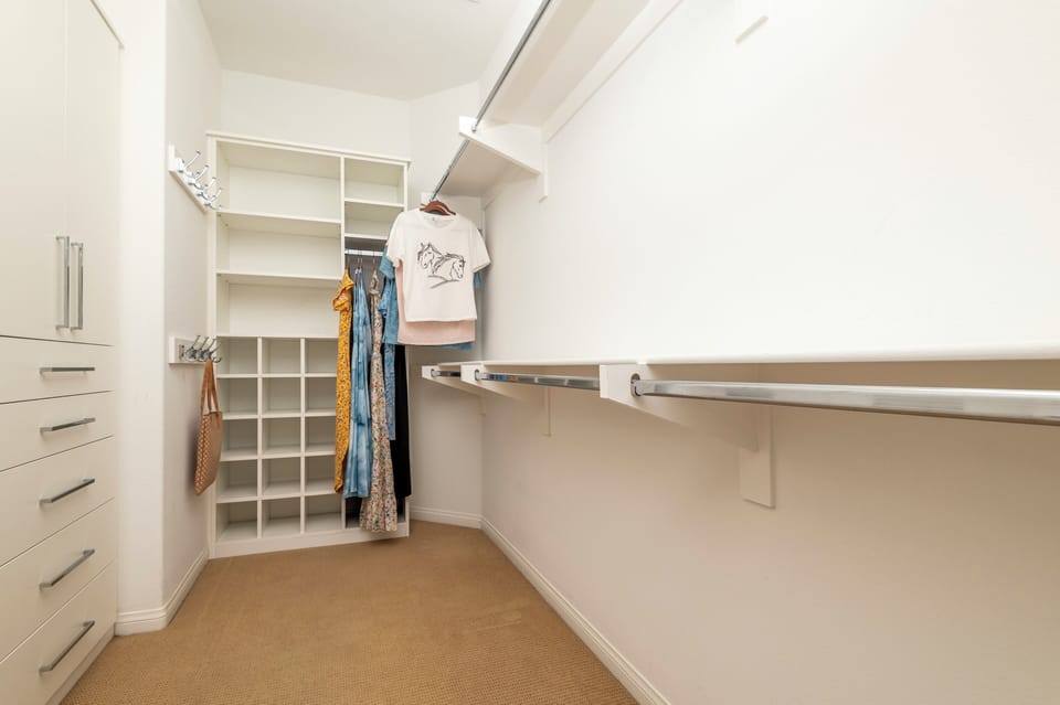 Master Bath Walk-in Closet, hang space, two chests drawers and pull-out hamper.