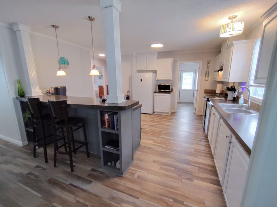 Kitchen with bar top and an open kitchen.