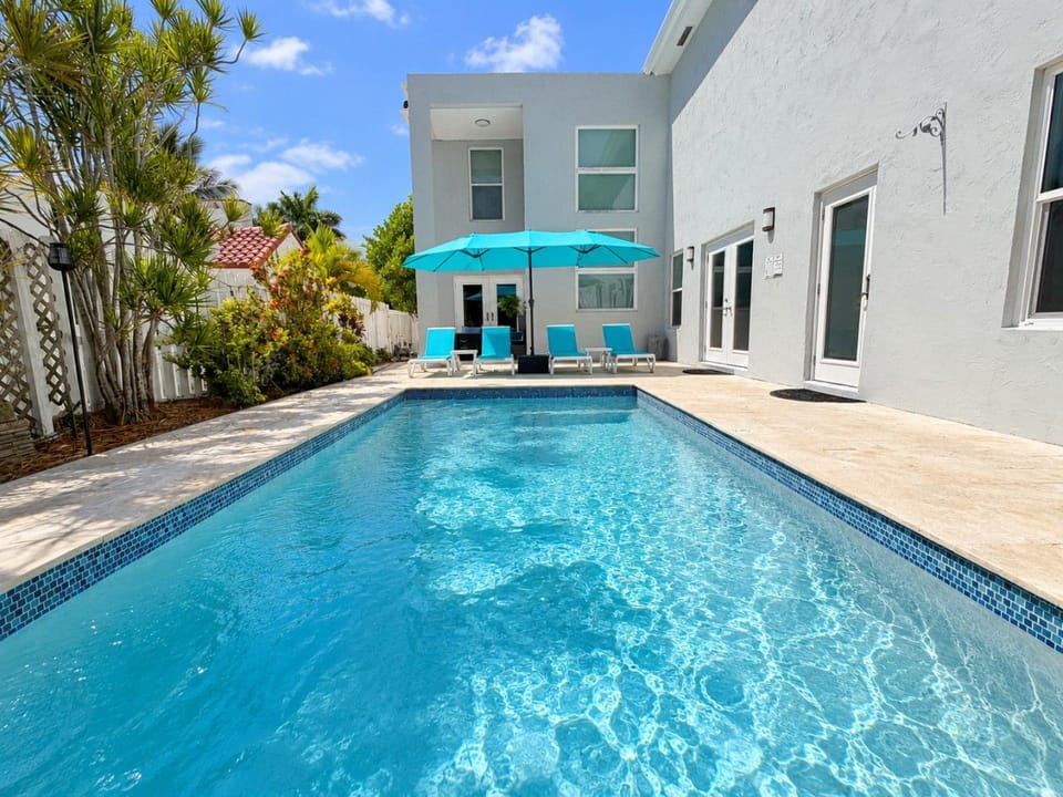 Enjoy sunny days by your private pool, complete with lounge chairs and a shaded seating area for relaxing.