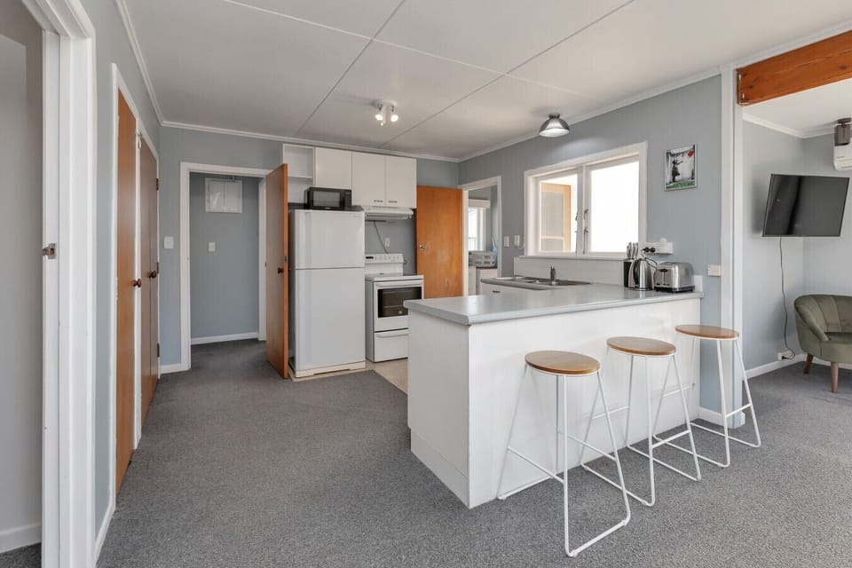 Fully equipped kitchen with full-sized oven, stove, and large refrigerator/freezer.