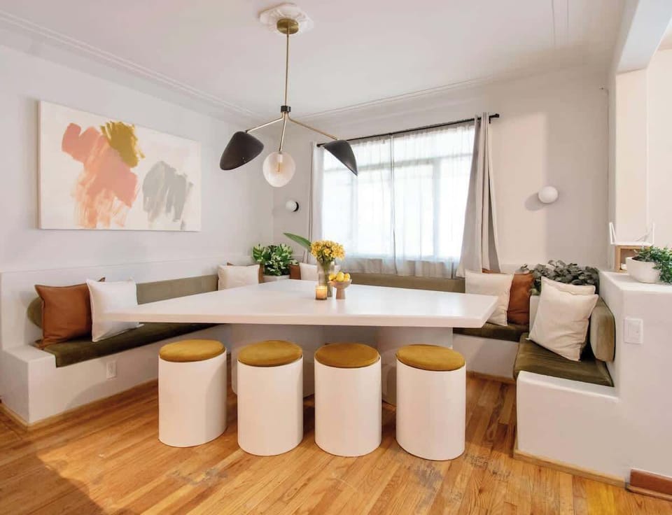 A bright, welcoming dining space designed for sharing moments. Built-in seating wraps the table, soft light filters in, and warm textures set the tone for long meals, easy conversations, and gatherings that naturally linger.