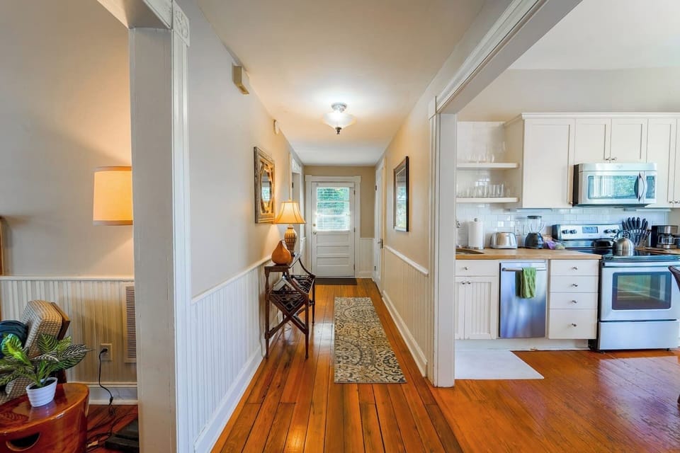 Original hardwood floor entrance with a spacious opening to your temporary home. 