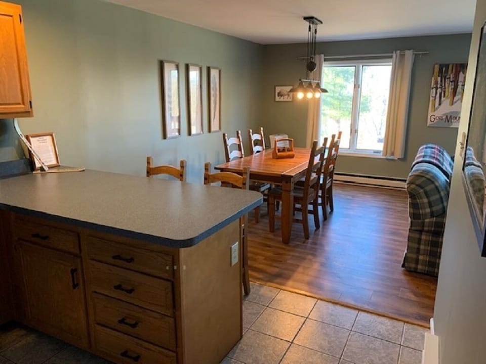 Cozy dining area and kitchen with warm wood finishes, mountain-inspired decor, and space to gather after a day of exploring.