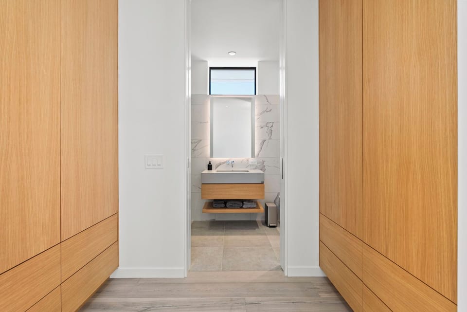 Thoughtfully designed with generous storage and a seamless flow into the private bath.