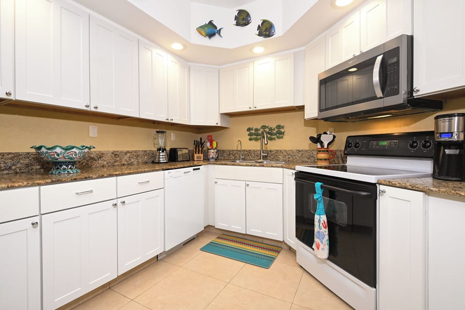 Cook up your favorite meals in this bright, fully equipped kitchen with modern appliances, granite countertops, and charming coastal décor that makes you feel right at home.