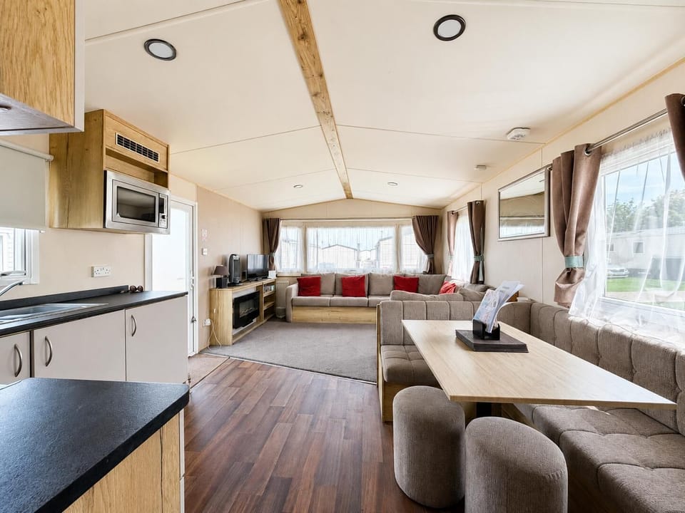 The large open plan lounge with its L shaped sofa is the perfect place to get the family together to discuss the day. They will love being able to plan your next adventure on the coast in Suffolk.