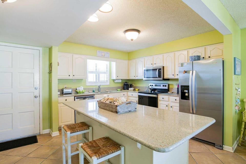 Bright, modern kitchen with spacious island and stainless steel appliances