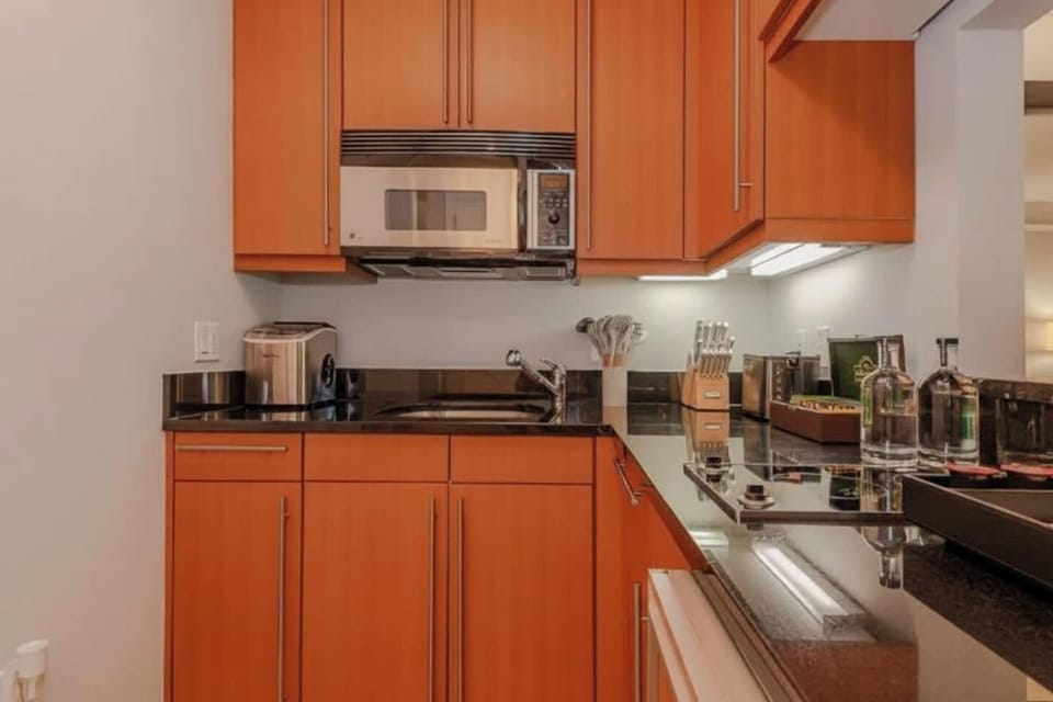 Enjoy the convenience of a smartly designed, well-equipped kitchen with a window into the living area, so everyone stays connected.