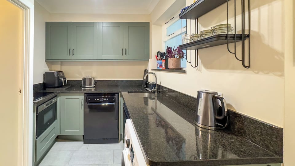 Well-equipped kitchen with quality appliances, cookware and ample workspace.