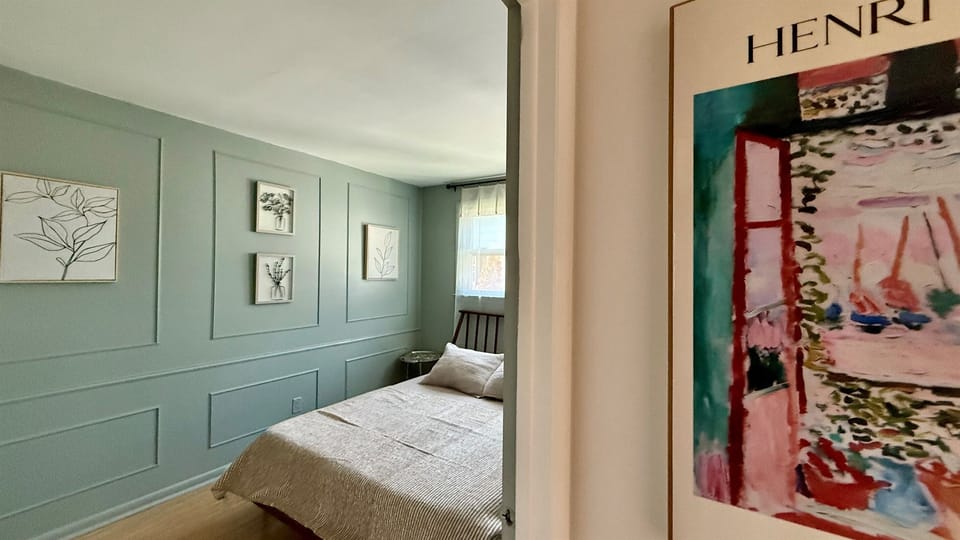 The second bedroom is softer hues with black out blinds for late mornings