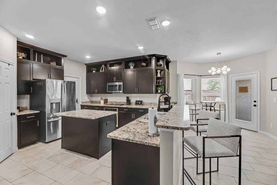 Kitchen
Granite countertops, stainless appliances, SMEG. and generous seating make this spacious kitchen perfect for morning coffee, family meals, and late-night conversations.