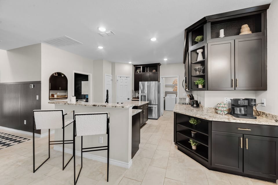 Kitchen
This fully stocked kitchen features granite countertops, stainless steel appliances, custom cabinetry, and spacious seating—perfect for everything from quick breakfasts to family feasts.