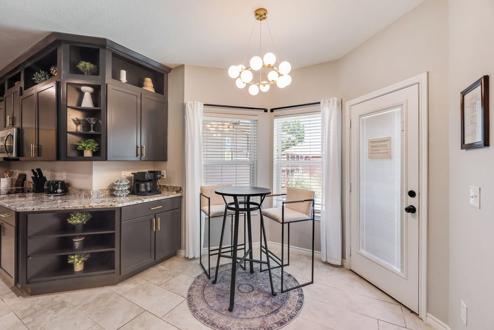 Breakfast Nook
Start your morning with coffee in this bright breakfast nook, framed by oversized windows, designer lighting, and cozy seating—the perfect spot to plan a day at PGA Frisco, The Star, or Universal Kids Resort. Coffee Provided