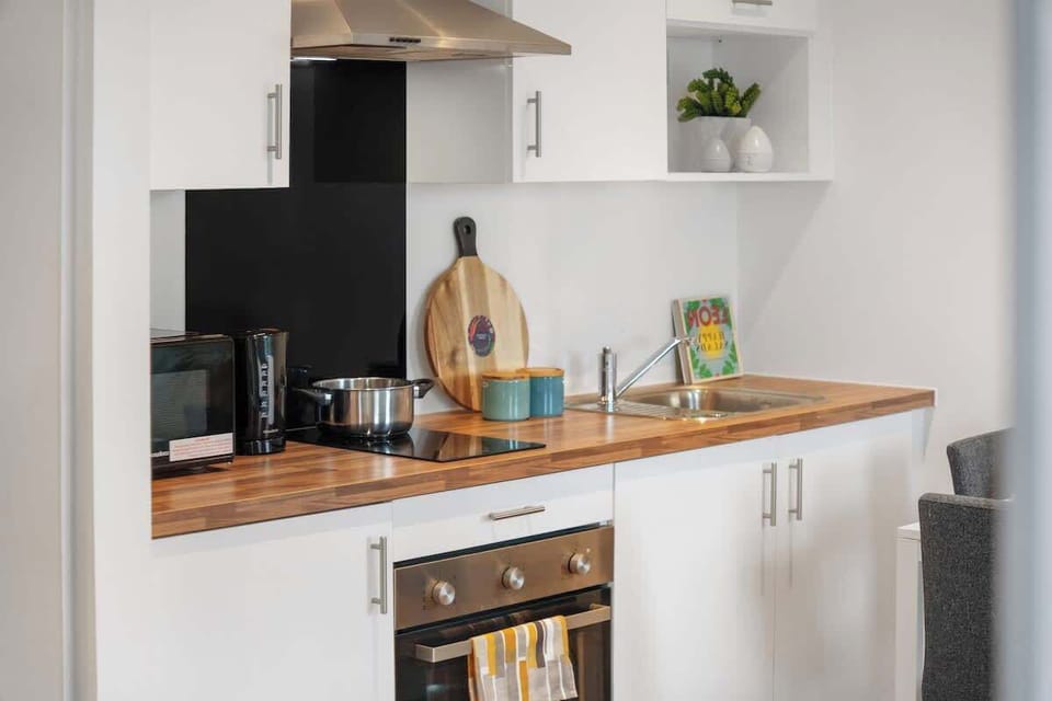 This studio apartment combines cooking, living, and sleeping spaces in one bright open-plan room. The kitchen includes an oven, fridge, and full cookware set for convenient dining throughout your stay.