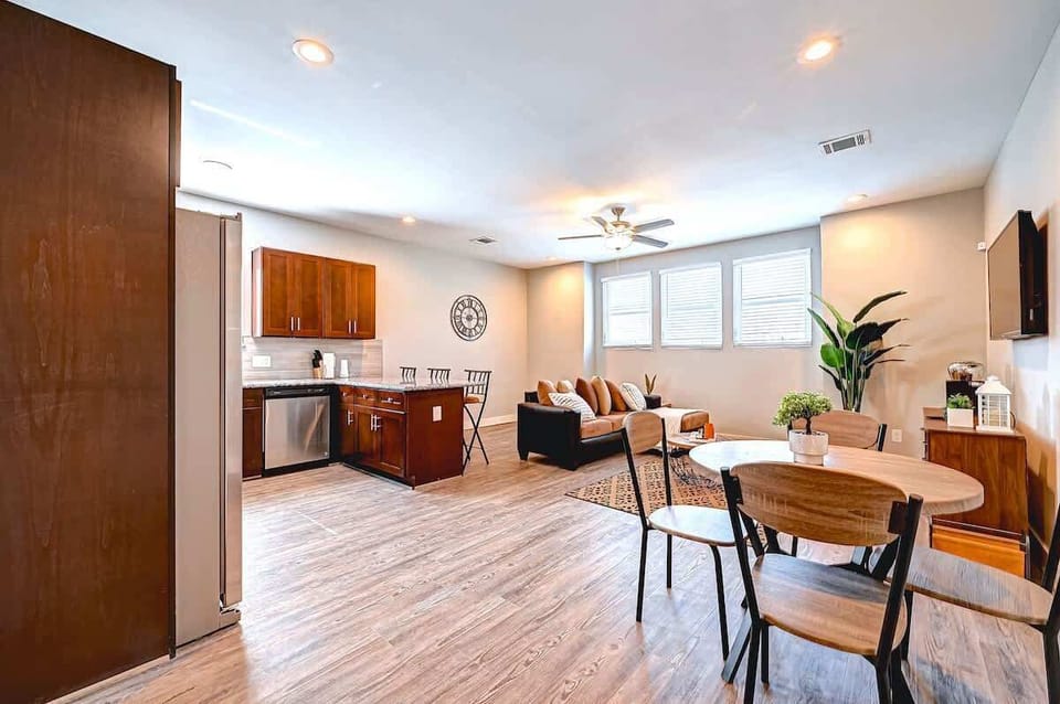 Bright and open-concept living space featuring a modern kitchen with stainless steel appliances, a cozy living area with natural light, and a stylish dining nook perfect for entertaining or relaxing.